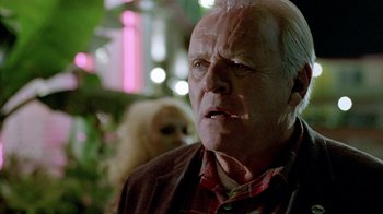 Movie still from “The World's Fastest Indian” (2005), directed by Roger Donaldson – An older man with a beard and a monkey in the background; Close Up shot, Over the shoulder angle