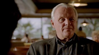 Movie still from “The World's Fastest Indian” (2005), directed by Roger Donaldson – An older man in a jacket and a black shirt; Close Up shot, Over the shoulder angle