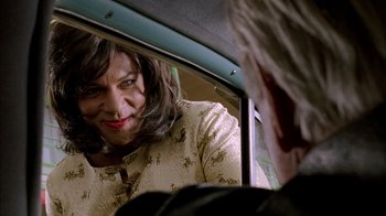 Movie still from “The World's Fastest Indian” (2005), directed by Roger Donaldson – A woman looking into a mirror in a car; Close Up shot, Over the shoulder angle