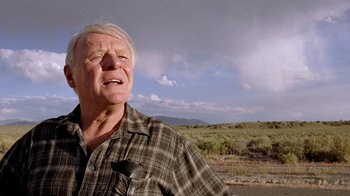 Movie still from “The World's Fastest Indian” (2005), directed by Roger Donaldson – An older man standing in the middle of a field; Close Up shot, Low angle