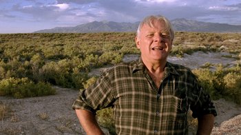 Movie still from “The World's Fastest Indian” (2005), directed by Roger Donaldson – An older man standing in the middle of the desert; Close Up shot, Low angle