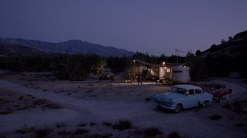 Movie still from “The World's Fastest Indian” (2005), directed by Roger Donaldson – An old car parked in the middle of a field; Extreme Wide shot, High angle