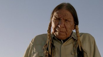 Movie still from “The World's Fastest Indian” (2005), directed by Roger Donaldson – An older man with long hair and a long beard; Close Up shot, Low angle