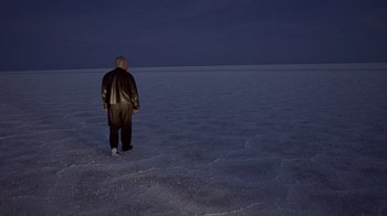 Movie still from “The World's Fastest Indian” (2005), directed by Roger Donaldson – A man standing in the middle of an empty field; Wide shot, High angle