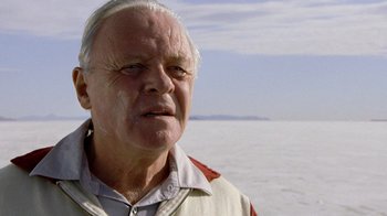 Movie still from “The World's Fastest Indian” (2005), directed by Roger Donaldson – An old man with a white beard and a white shirt; Close Up shot, Low angle