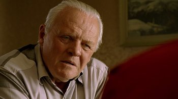 Movie still from “The World's Fastest Indian” (2005), directed by Roger Donaldson – An older man with white hair looking at the camera; Close Up shot, Over the shoulder angle