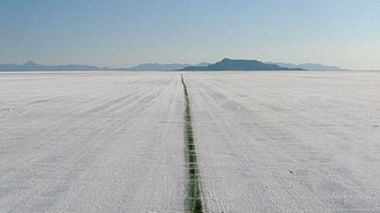 Movie still from “The World's Fastest Indian” (2005), directed by Roger Donaldson – A road that has been cut into the ground; Extreme Wide shot, High angle