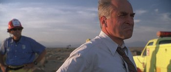 Movie still from “The X Files” (1998), directed by Rob Bowman – An older man wearing a white dress shirt and a tie; Close Up shot, Low angle