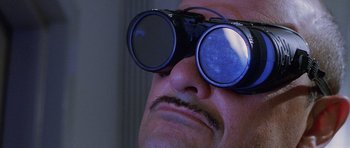 Movie still from “The X Files” (1998), directed by Rob Bowman – A person wearing a pair of goggles; Extreme Close Up shot, Low angle