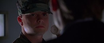 Movie still from “The X Files” (1998), directed by Rob Bowman – A man in a military uniform looking into a mirror; Close Up shot, High angle