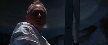 Movie still from “The X Files” (1998), directed by Rob Bowman – A person in a white shirt; Close Up shot, Low angle