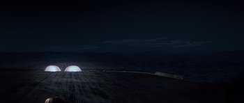 Movie still from “The X Files” (1998), directed by Rob Bowman – A light shines in the dark on a field; Extreme Wide shot, High angle