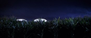 Movie still from “The X Files” (1998), directed by Rob Bowman – A field of grass with a full moon in the background; Extreme Wide shot, Low angle