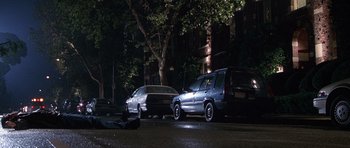 Movie still from “The X Files” (1998), directed by Rob Bowman – Two cars parked on the side of the road at night; Extreme Wide shot, High angle