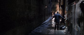 Movie still from “The X Files” (1998), directed by Rob Bowman – Two men are walking down a dark alley; Wide shot, High angle