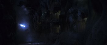 Movie still from “The X Files” (1998), directed by Rob Bowman – A dark room with a lot of light coming from the ceiling; Extreme Wide shot, High angle