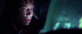 Movie still from “The X Files” (1998), directed by Rob Bowman – A person looking at the camera; Close Up shot, Low angle