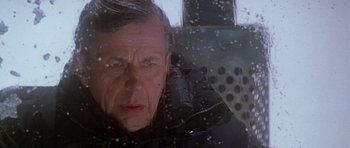 Movie still from “The X Files” (1998), directed by Rob Bowman – A person looking through a window; Close Up shot, Low angle