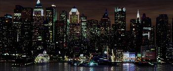 Movie still from “There Will Be Blood” (2007), directed by Paul Thomas Anderson – A large city lit up at night with lights; Extreme Wide shot, High angle