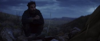 Movie still from “There Will Be Blood” (2007), directed by Paul Thomas Anderson – A man standing on top of a hill at night; Medium shot, Low angle