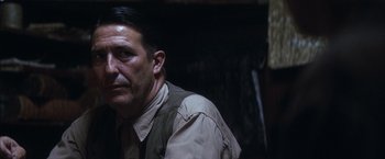 Movie still from “There Will Be Blood” (2007), directed by Paul Thomas Anderson – A person wearing a vest; Close Up shot, Over the shoulder angle