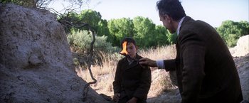 Movie still from “There Will Be Blood” (2007), directed by Paul Thomas Anderson – A man touching a young boy's head in a field; Medium shot, Over the shoulder angle