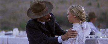 Movie still from “There Will Be Blood” (2007), directed by Paul Thomas Anderson – A man and a woman are touching each other's neck; Close Up shot, Over the shoulder angle