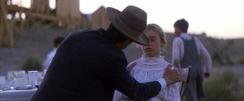 Movie still from “There Will Be Blood” (2007), directed by Paul Thomas Anderson – A man and a little girl in a dress and a hat; Medium shot, Over the shoulder angle
