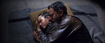 Movie still from “There Will Be Blood” (2007), directed by Paul Thomas Anderson – A man and a woman laying on the ground; Close Up shot, Overhead angle