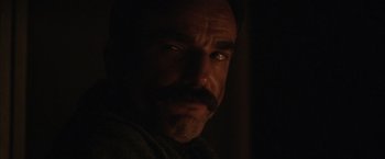Movie still from “There Will Be Blood” (2007), directed by Paul Thomas Anderson – A person with a mustache; Close Up shot, Over the shoulder angle