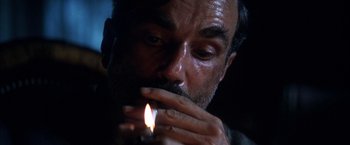 Movie still from “There Will Be Blood” (2007), directed by Paul Thomas Anderson – A person lighting a cigarette; Close Up shot, Low angle