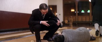 Movie still from “There Will Be Blood” (2007), directed by Paul Thomas Anderson – A man kneeling down on the floor next to another man; Medium shot, High angle