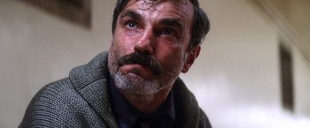 Movie still from “There Will Be Blood” (2007), directed by Paul Thomas Anderson – An older man with a beard and a mustache; Close Up shot, Low angle