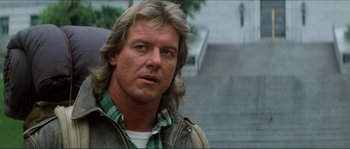 Movie still from “They Live” (1988), directed by John Carpenter – A person with long hair; Close Up shot, Low angle