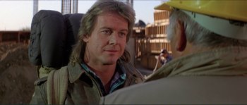 Movie still from “They Live” (1988), directed by John Carpenter – A person wearing a jacket; Close Up shot, Over the shoulder angle