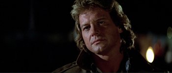 Movie still from “They Live” (1988), directed by John Carpenter – A person with long hair; Close Up shot, Low angle