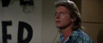 Movie still from “They Live” (1988), directed by John Carpenter – A person looking up at something; Close Up shot, Low angle