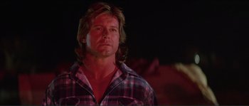 Movie still from “They Live” (1988), directed by John Carpenter – A person wearing a plaid shirt; Close Up shot, Low angle