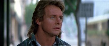 Movie still from “They Live” (1988), directed by John Carpenter – A person wearing a plaid shirt; Close Up shot, Low angle