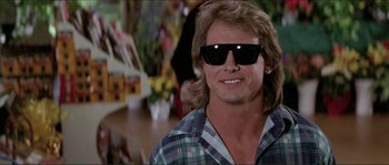 Movie still from “They Live” (1988), directed by John Carpenter – A person wearing sunglasses; Close Up shot, Over the shoulder angle