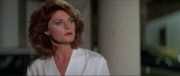 Movie still from “They Live” (1988), directed by John Carpenter – A person wearing a white shirt; Close Up shot, Over the shoulder angle