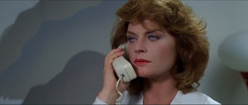 Movie still from “They Live” (1988), directed by John Carpenter – A person talking on a phone; Close Up shot, Low angle