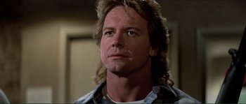 Movie still from “They Live” (1988), directed by John Carpenter – A person with long hair; Close Up shot, Low angle