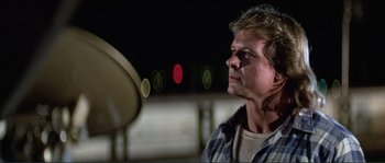 Movie still from “They Live” (1988), directed by John Carpenter – A person looking at a mirror; Close Up shot, Low angle