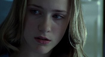 Movie still from “Thirteen” (2003), directed by Catherine Hardwicke – A young woman's face in the dark; Close Up shot, Over the shoulder angle