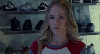 Movie still from “Thirteen” (2003), directed by Catherine Hardwicke – A woman with blonde hair wearing a red and white shirt; Close Up shot, Over the shoulder angle