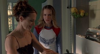 Movie still from “Thirteen” (2003), directed by Catherine Hardwicke – Two young women standing next to each other in front of a window; Medium shot, Over the shoulder angle