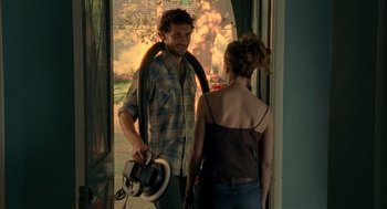 Movie still from “Thirteen” (2003), directed by Catherine Hardwicke – A man and a woman standing in front of a door; Medium shot, Over the shoulder angle