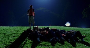 Movie still from “Thirteen” (2003), directed by Catherine Hardwicke – A group of people laying in the grass at night; Extreme Wide shot, High angle