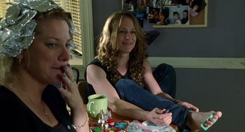 Movie still from “Thirteen” (2003), directed by Catherine Hardwicke – Two women sitting at a table with a cup of coffee; Medium shot, High angle